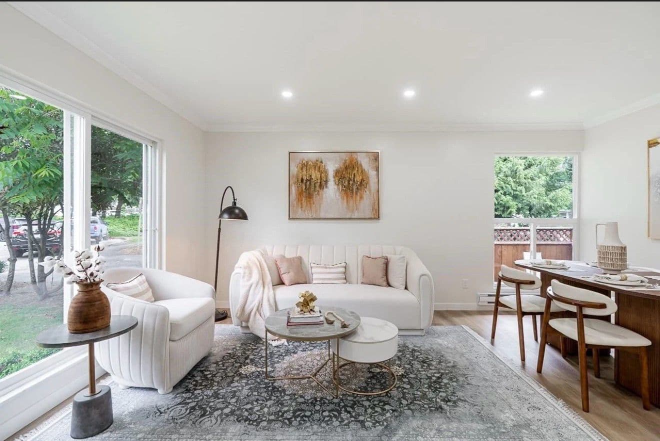 Staged living room with a traditional Persian rug, cream loveseat and blush accents